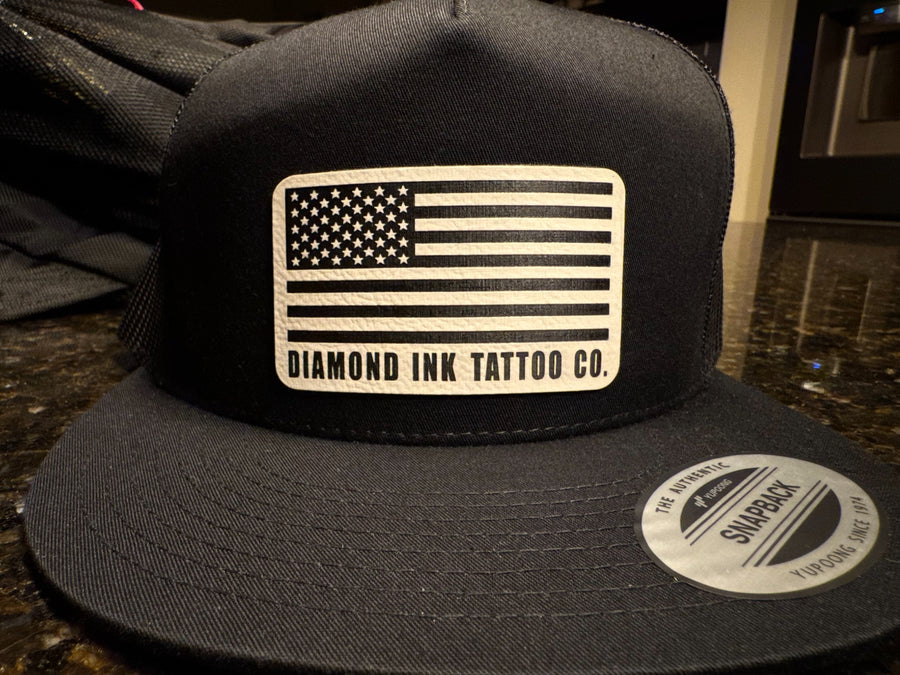 Black custom Diamond Ink Tattoo Co. snapback with American flag patch