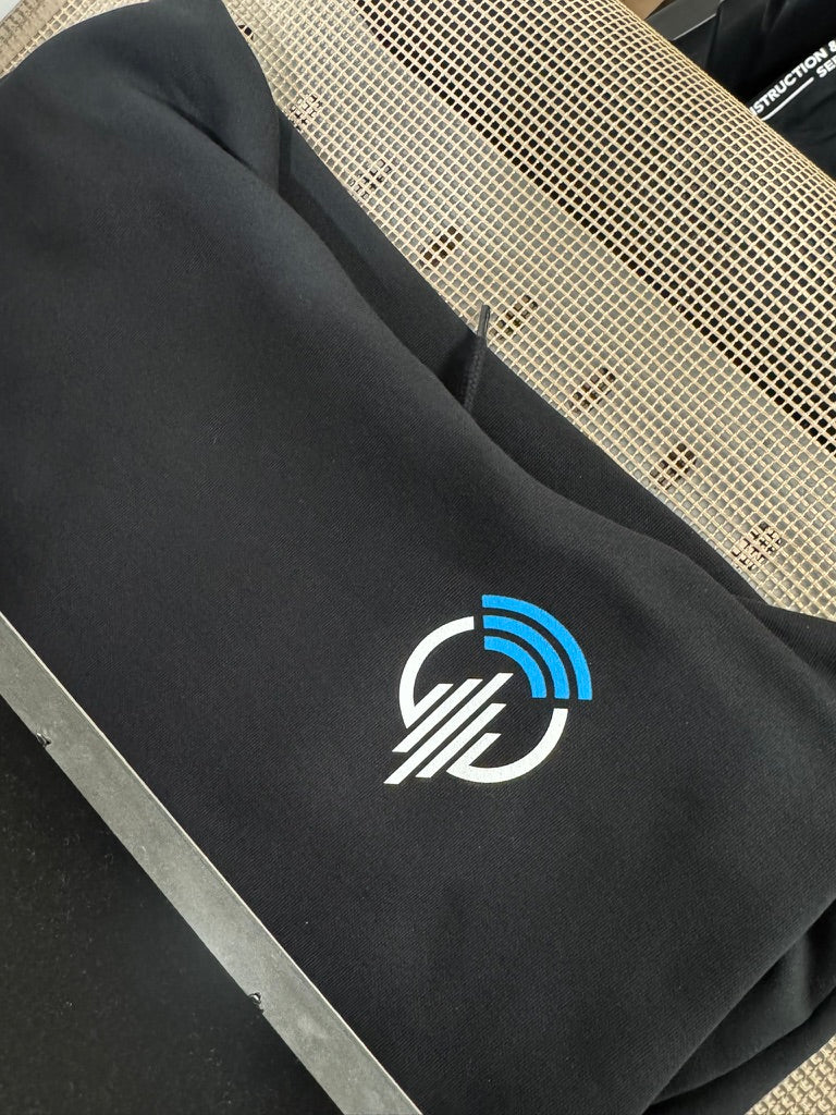 Blue and white chest logo screen print on black apparel