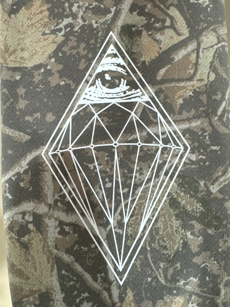 Fine-line diamond eye white screen print on camouflage fabric